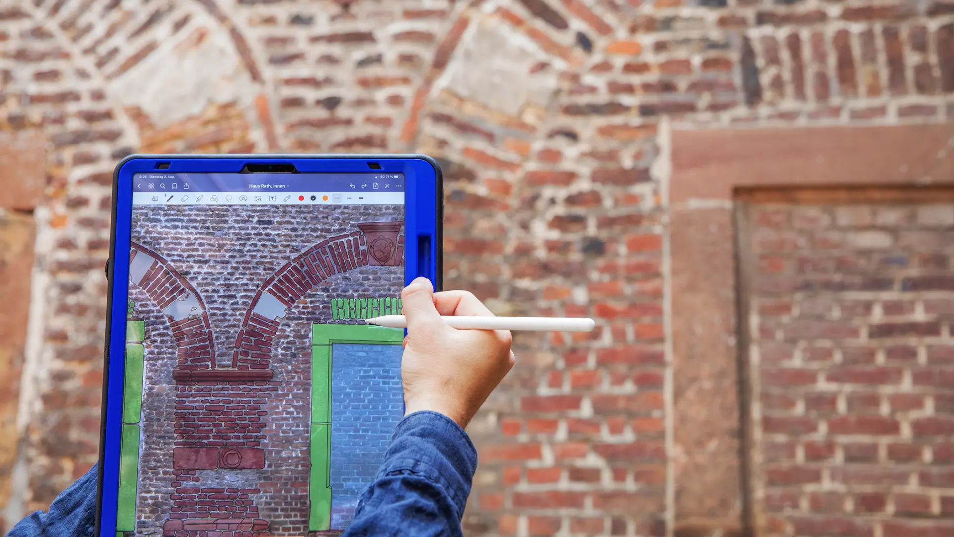 Bauforscher erfasst Stein für Stein am Tablet digital eine Backsteinfassade. 