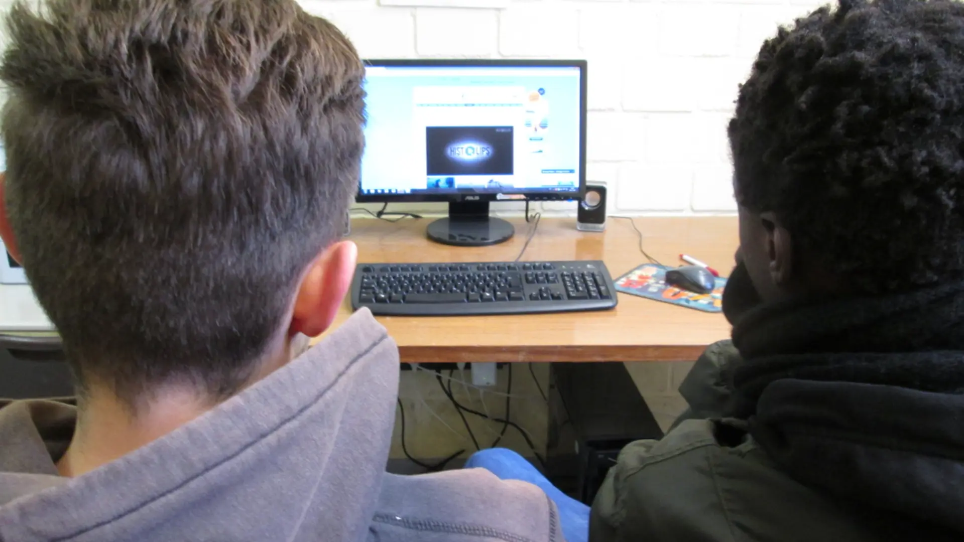 Zwei Schüler sitzen im Unterricht vor dem PC