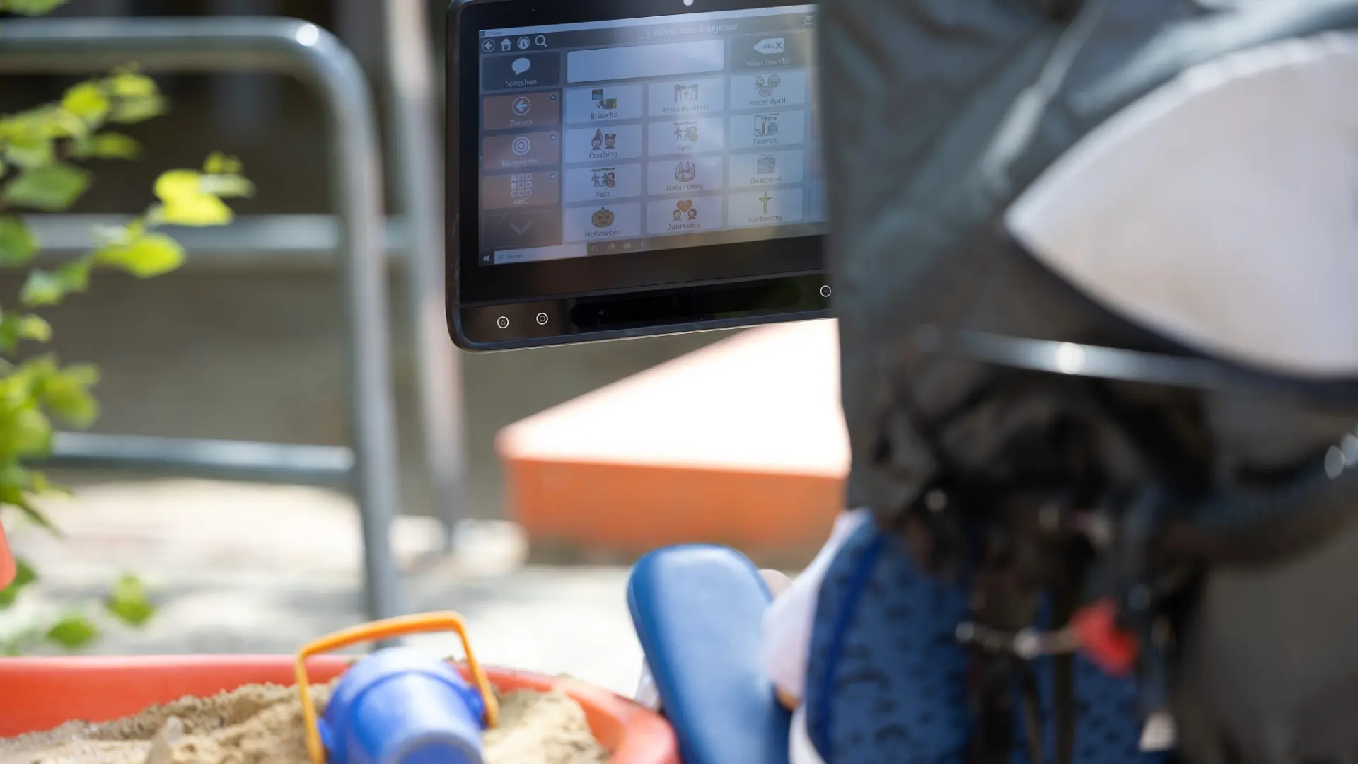 Rückansicht eines Rollstuhls mit Assistiver Technologie zur Kommunikation