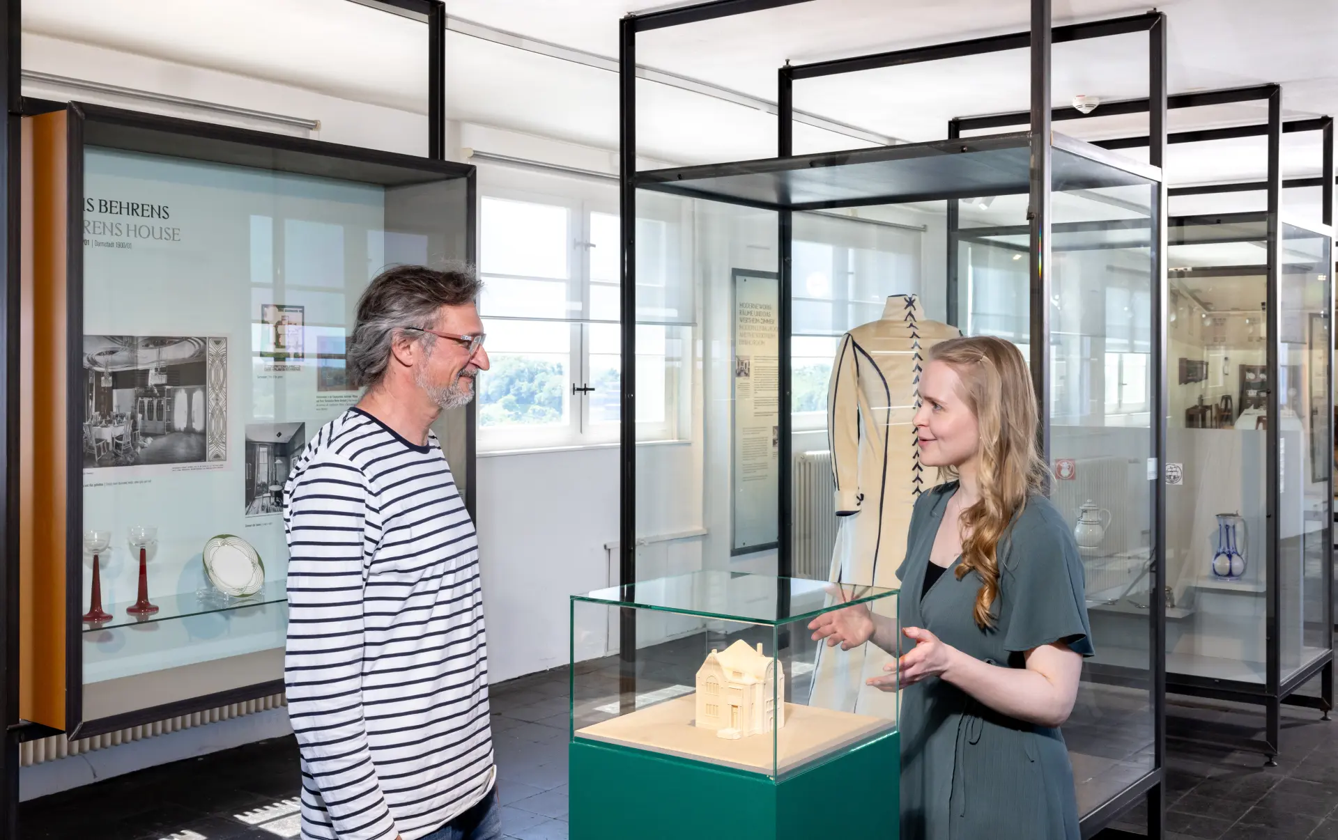 Ein Mann und eine Frau sprechen in einer Ausstellung miteinander
