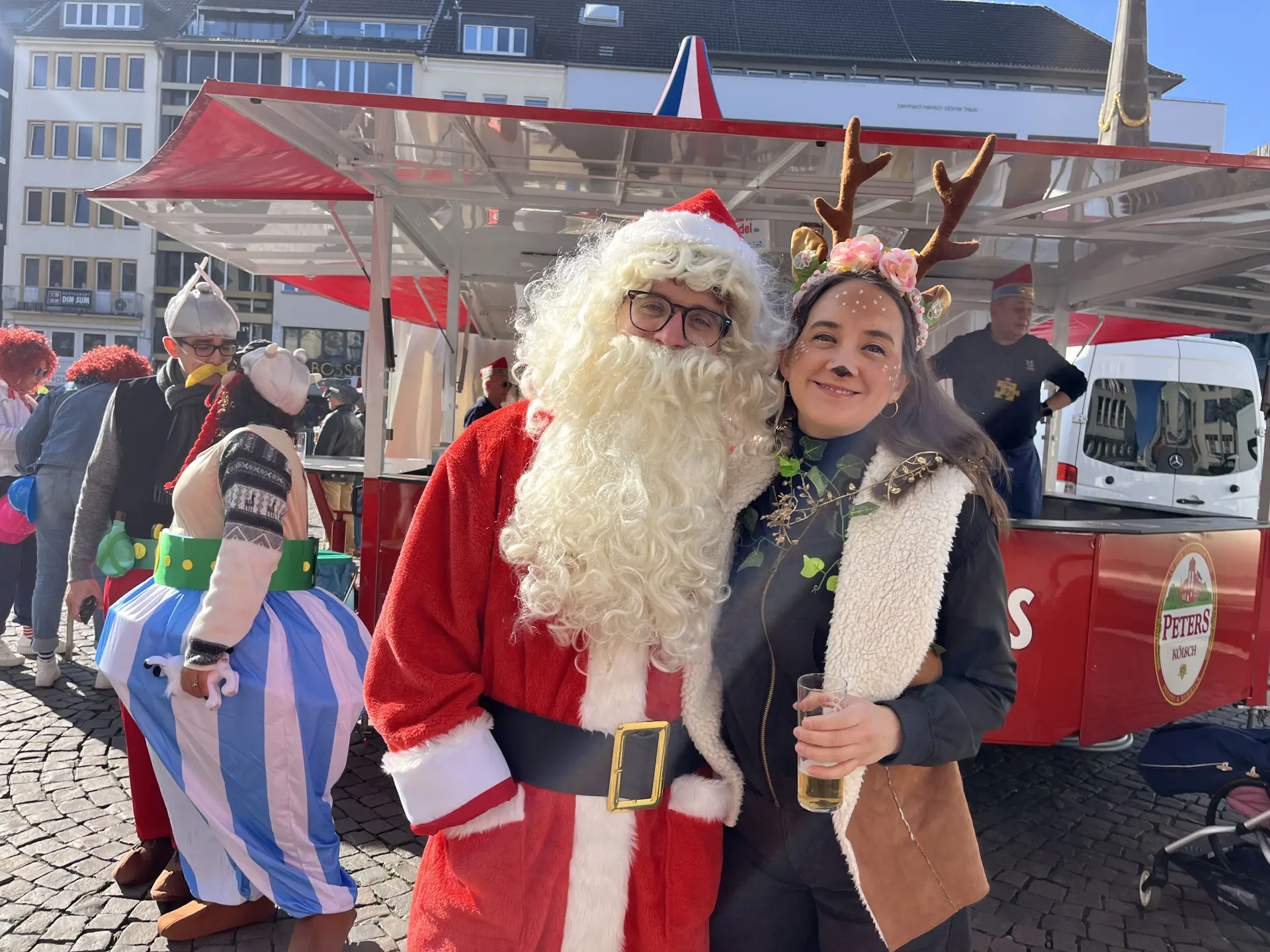 Links ein verkleideter Karnevalist als Weihnachtsmann, rechts eine Karnevalistin verkleidet als Rentier