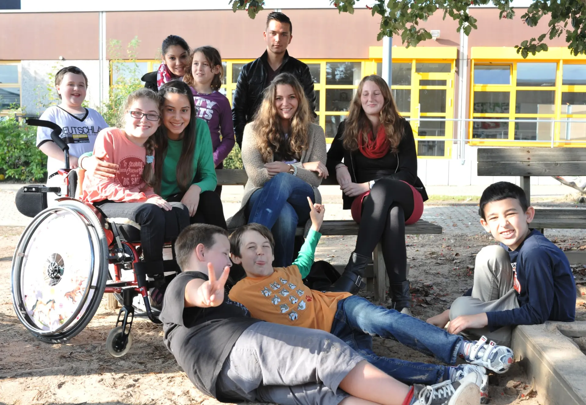 Gruppenbild: Freiwillige mit Schüler*innen auf dem Schulhof