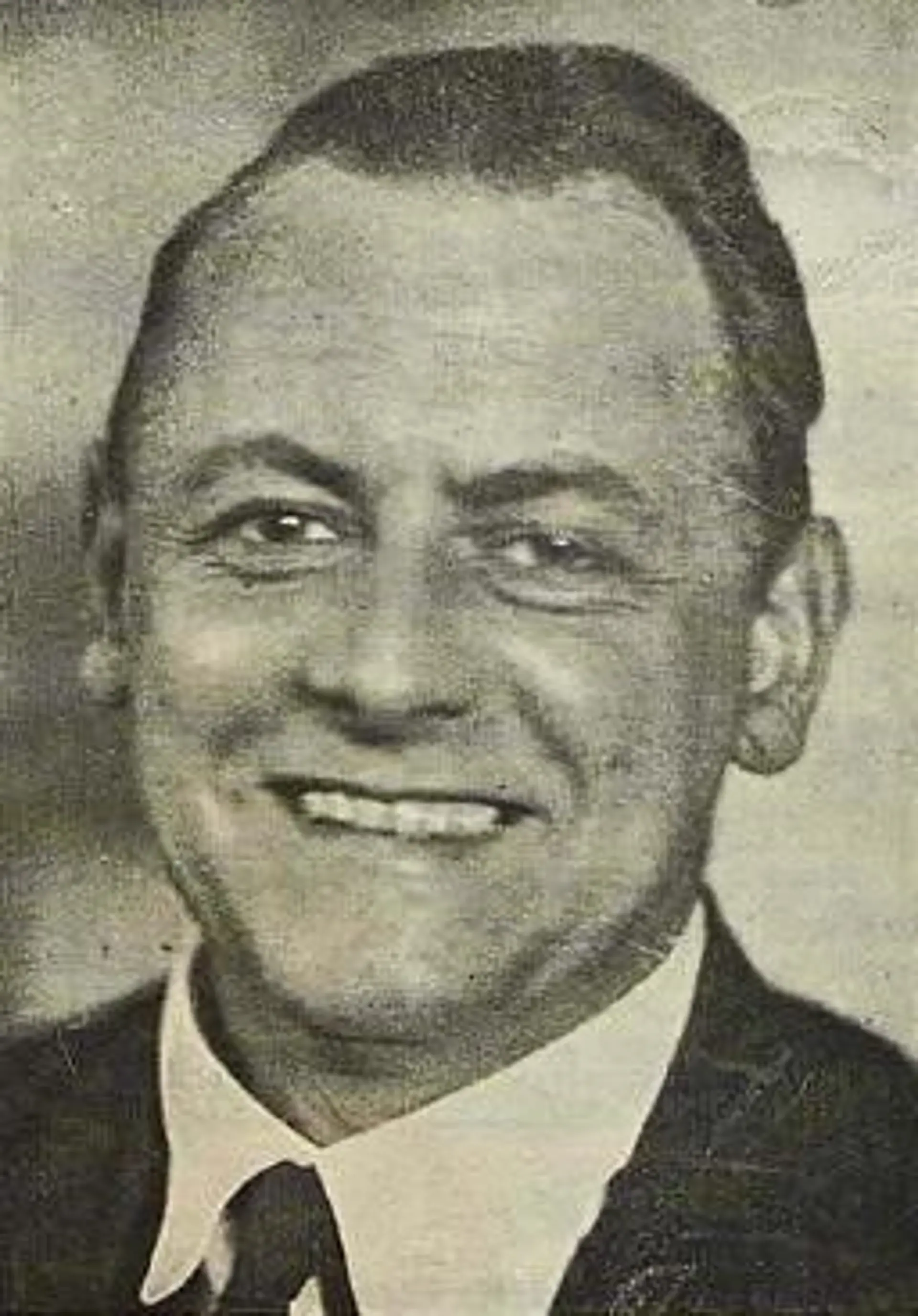 Das Porträt von Kurt Schwitters in Schwarzweiß. Er lächelt freundlich in die Kamera.