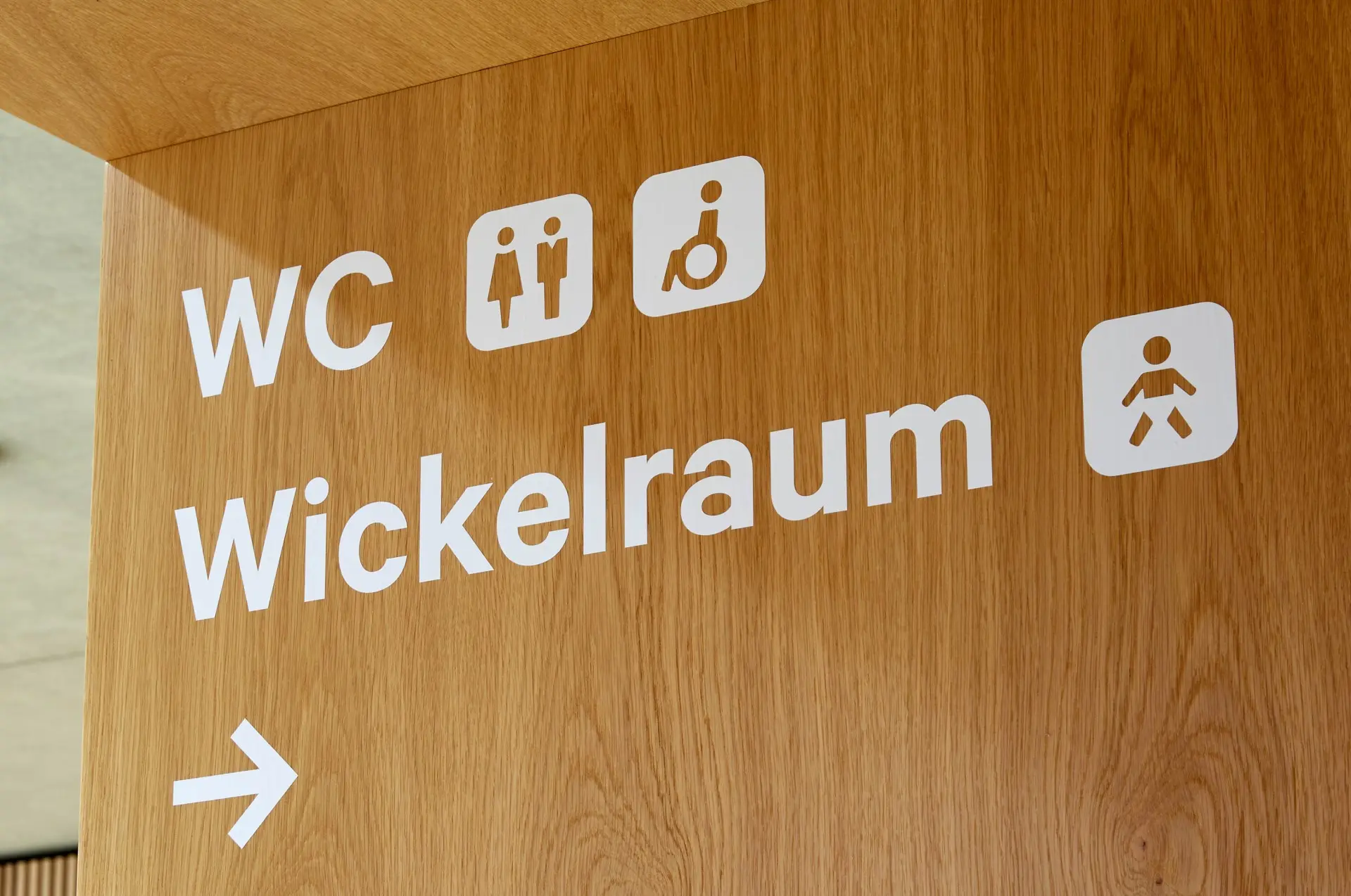 Wandhinweise auf barrierefreie Toiletten und Wickelraum