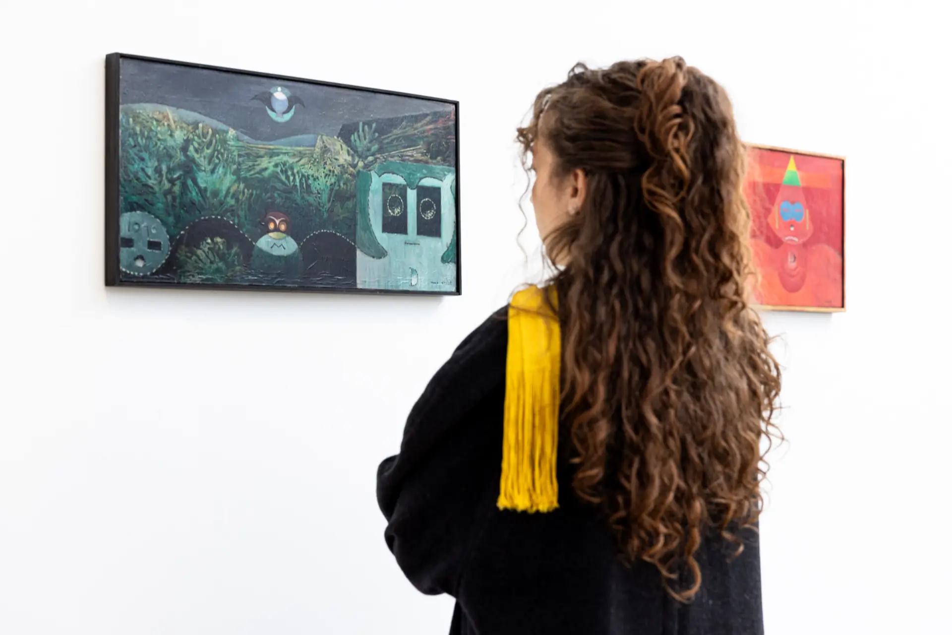 Junge Frau schaut sich Gemälde an