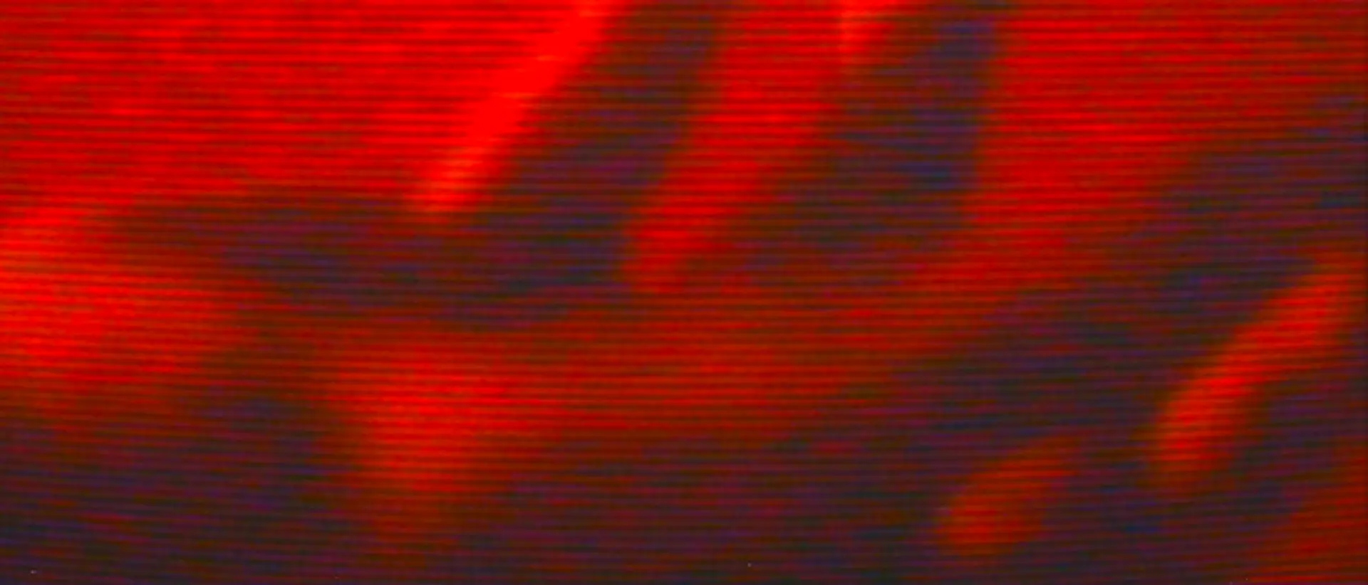 Eine Hand auf schwarz-roter Fläche