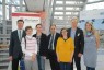 Eine Gruppe von Männern und Frauen steht in einem Eingangsbereich