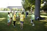 Kinder beim Spielen auf einer Wiese.