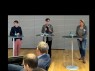 Drei Personen stehen jeweils hinter einem Rednerpult