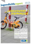 Ein Kinderfahrrad an einen rot/weißen Poller angelehnt