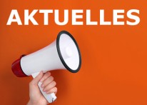 Eine Hand hält ein Megafon. Darüber steht "Aktuelles".