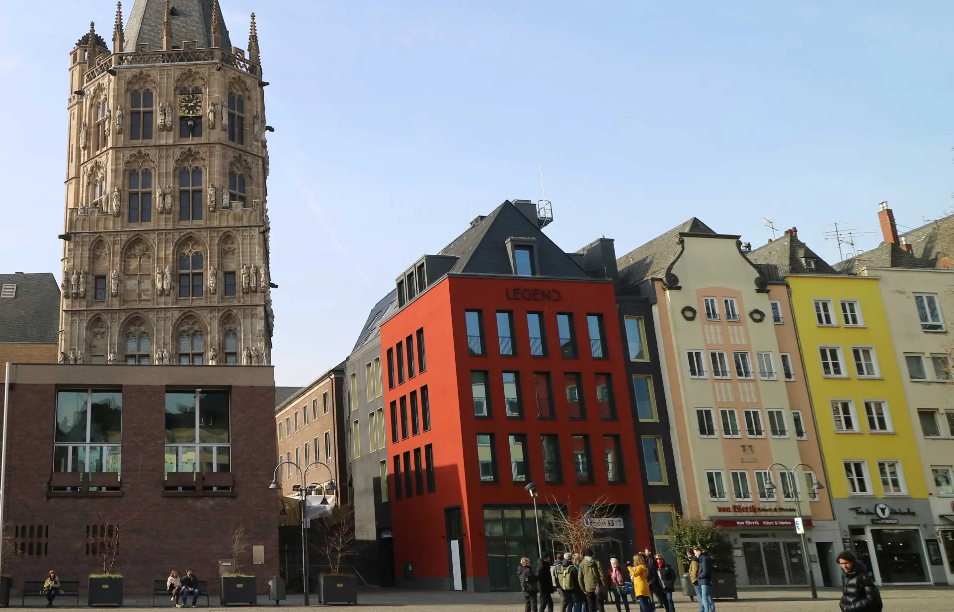 Eine Reihe von Gebäuden.  In der Mitte ist ein rotes Gebäude zu sehen, auf dem Legend steht.