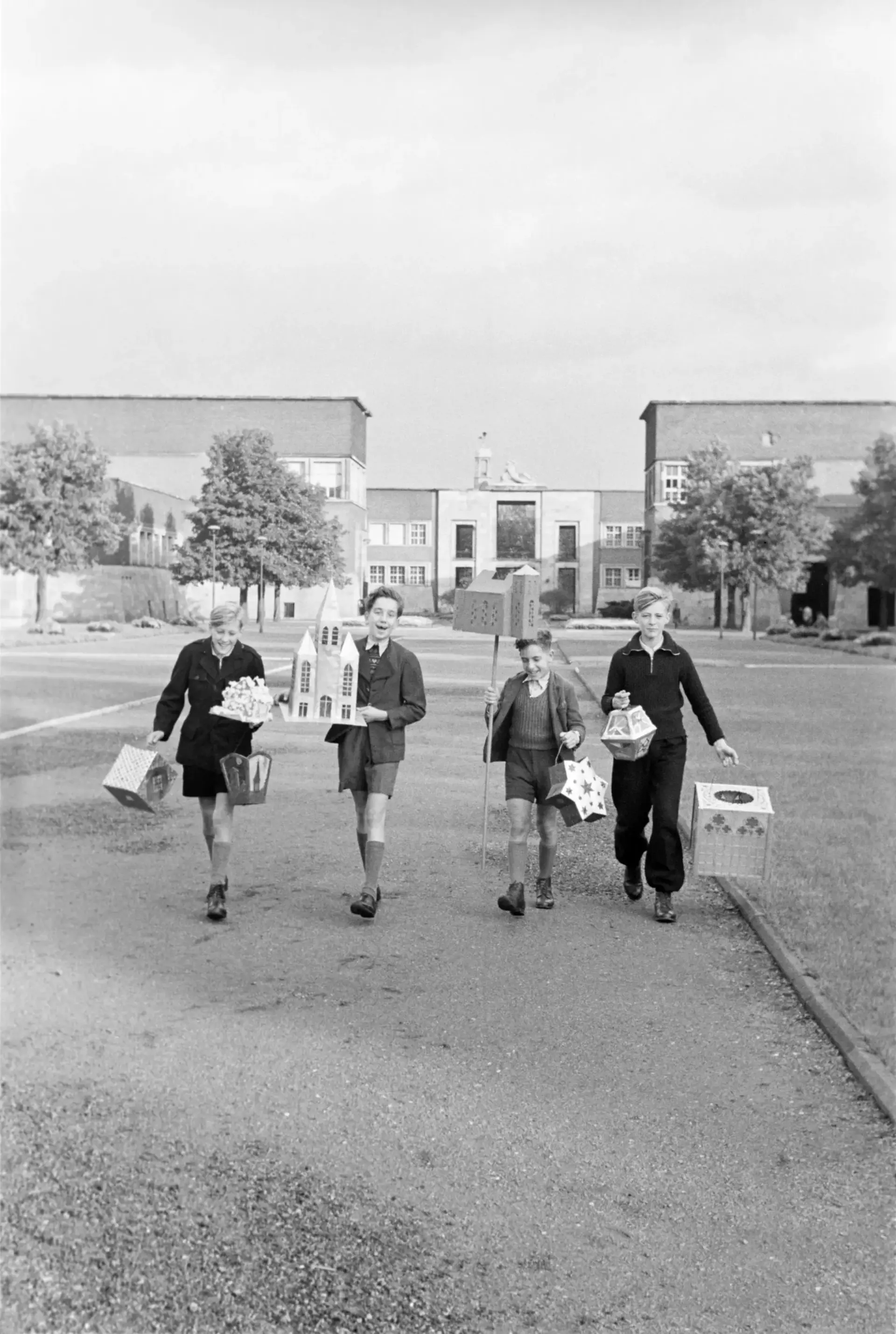 Vier Jungen mit Laternen.