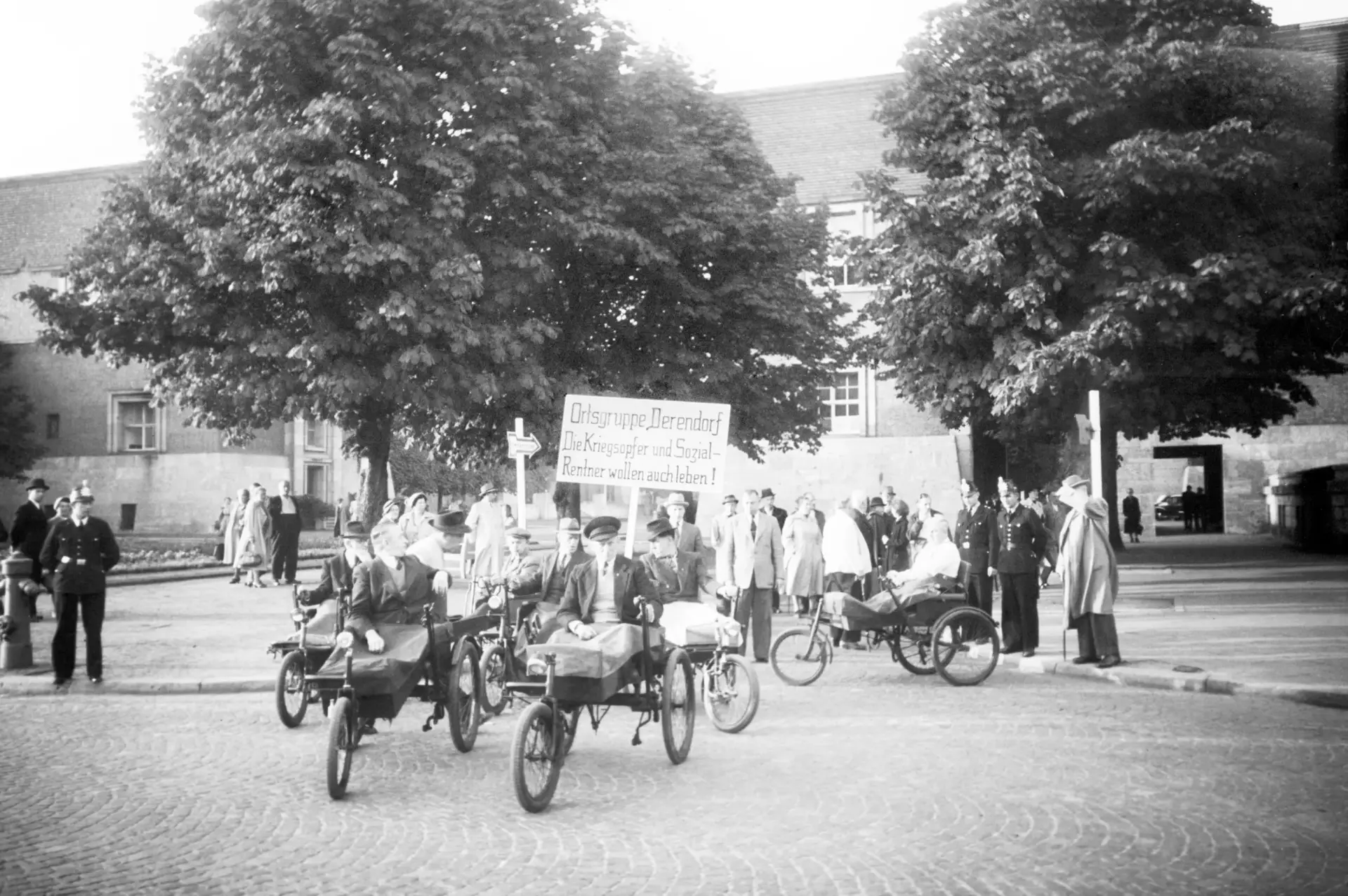 Männer mit Rollstühlen während einer Demonstration.